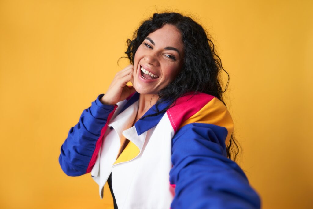 a young girl taking a selfie with a big smile